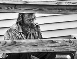 homeless man smoking a joint in maine in black and white portrait